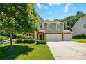 Beautiful home with a well-maintained lawn, mature trees, and a spacious driveway leading to a two-car garage at 3106 Crosswind Dr, Fort Mill, SC 29707