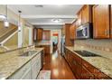 Modern kitchen with granite countertops, stainless steel appliances, hardwood floors, and ample cabinet space at 3106 Crosswind Dr, Fort Mill, SC 29707