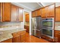 Well-appointed kitchen featuring stainless steel appliances, rich wood cabinetry, and granite countertops at 3106 Crosswind Dr, Fort Mill, SC 29707