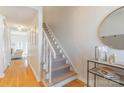 Bright foyer with hardwood floors, staircase and decor table with mirror at 3615 Maple Glenn Ln, Charlotte, NC 28226