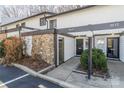 Charming townhome featuring a stone facade and inviting front entrance with landscaped garden at 3615 Maple Glenn Ln, Charlotte, NC 28226