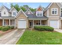 Inviting townhome boasting a well-manicured lawn, brick accents, and attached garages at 4460 Coventry Row Ct, Charlotte, NC 28270