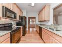 Well-equipped kitchen with stainless steel appliances, sleek countertops, and wood cabinets at 4460 Coventry Row Ct, Charlotte, NC 28270