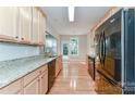 Modern kitchen with stainless steel appliances, granite countertops, and ample cabinet space at 4460 Coventry Row Ct, Charlotte, NC 28270