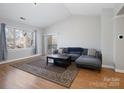 Spacious living room with natural light, cozy seating, and a sliding glass door to the balcony at 5617 Fairview Rd # 9, Charlotte, NC 28209