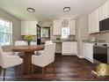 Bright kitchen with white cabinetry, stainless steel appliances, and a breakfast nook bathed in natural light at 6225 Macon St, Charlotte, NC 28208