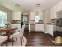 Bright kitchen with white cabinetry, stainless steel appliances, and a breakfast nook bathed in natural light at 6225 Macon St, Charlotte, NC 28208