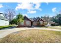 Inviting brick home with manicured lawn and attached garages offer convenience and curb appeal at 6618 Alexander Rd, Charlotte, NC 28270