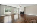 Spacious living room with hardwood floors, fireplace, and large windows that provide natural light at 6618 Alexander Rd, Charlotte, NC 28270