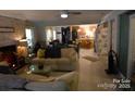 Open concept living room with a fireplace and plenty of natural light, flowing into the kitchen area at 746 Sinclair Dr, Monroe, NC 28112