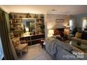 Cozy living room with a brick fireplace and custom built-in shelving offering storage and display space at 746 Sinclair Dr, Monroe, NC 28112