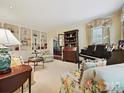Inviting living room with custom built-ins, a piano, and comfortable seating at 828 Colville Rd, Charlotte, NC 28207