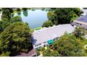 Aerial view of a condo complex near a serene lake, surrounded by mature trees and lush greenery at 8356 Meadow Lakes Dr, Charlotte, NC 28210