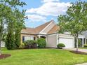Eye-catching exterior with lush yard, pretty landscaping, and stone accents offers inviting curb appeal at 8603 Robinson Meadow Ct, Charlotte, NC 28277