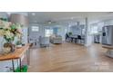Spacious open-concept living area with hardwood floors, natural light, and seamless flow to the kitchen at 8607 Larchmont Cir, Charlotte, NC 28214
