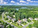 Aerial view of a beautiful home in a lush community near a serene lake and mountains at 909 Autumn Glen Ct, Lake Wylie, SC 29710