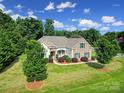 An elevated view of a beautiful home with a well-maintained lawn and mature trees at 909 Autumn Glen Ct, Lake Wylie, SC 29710