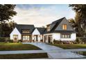Charming two-story home featuring a well-manicured lawn, an attached two car garage, and a welcoming entrance at 0000 Woodhill Cove Ln # 5, Denver, NC 28037