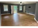 Open living room with lots of light featuring stylish wood-look floors and a ceiling fan at 103 Sycamore Rd, Salisbury, NC 28147