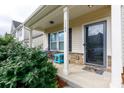 Inviting covered front porch with stone accents and cozy seating area at 1148 Bannockburn Ave, Rock Hill, SC 29732