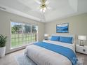Bright bedroom featuring a large window with views, a comfortable bed, and modern decor for a serene retreat at 1148 Stallings Rd, Matthews, NC 28104