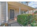 Cozy front porch with a welcoming entryway and landscaped shrubbery at 1219 Century Dr, Clover, SC 29710