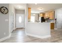 Inviting hallway leading to a bright, modern kitchen with wood-look flooring and neutral paint at 129 Sara Ln, Statesville, NC 28625