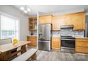 Well-lit kitchen with stainless steel refrigerator, ample wooden cabinets, and stylish countertop at 129 Sara Ln, Statesville, NC 28625