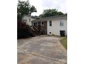 The back of this home has off-street parking and a wooden staircase at 145 Honeycutt Rd, Salisbury, NC 28144