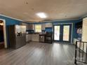 Bright kitchen with stainless steel appliances, light gray cabinets, and an outdoor view from the double patio doors at 145 Honeycutt Rd, Salisbury, NC 28144