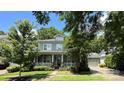 Charming home featuring a cozy front porch, complemented by lush landscaping and a well-manicured lawn at 16909 Red Cow Rd, Charlotte, NC 28277