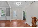 Elegant foyer featuring hardwood floors, a modern chandelier, and abundant natural light at 16909 Red Cow Rd, Charlotte, NC 28277