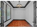 Stylish office featuring a modern chandelier, contrasting trim, and plenty of natural light at 16909 Red Cow Rd, Charlotte, NC 28277