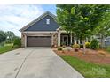 Charming home featuring a stone and siding exterior, a well-manicured lawn, and a two-car garage at 1712 Askern Ct, Waxhaw, NC 28173
