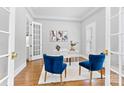 Bright home office with hardwood floors, white trim, double doors, and neutral decor at 1806 Asbury Hall Ct, Charlotte, NC 28209