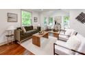 Sun-drenched living room with stylish furnishings, hardwood floors and neutral colors at 2114 Thurmond Pl, Charlotte, NC 28205