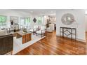 Bright, open-concept living room with hardwood floors, modern furnishings, and stylish decor at 2114 Thurmond Pl, Charlotte, NC 28205