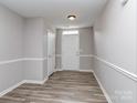 Inviting entryway features neutral walls, a white door, and durable wood-look flooring at 2169 Belle Vernon Ave, Charlotte, NC 28210