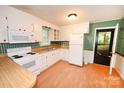 Well-lit kitchen featuring white appliances, plenty of cabinets, and butcher block countertops at 2625 Glenn St, Newton, NC 28658