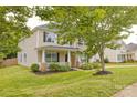 Beautiful two-story home featuring a cozy front porch, nicely landscaped lawn, and classic design at 4001 Brook Valley Run, Monroe, NC 28110