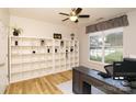 Bright office with a ceiling fan, large shelving unit, and a large window that offers plenty of natural light at 4001 Brook Valley Run, Monroe, NC 28110