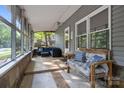 Relaxing screened-in porch featuring tiled floors, comfortable seating, and ample natural light at 4043 Windward Dr, Fort Mill, SC 29708