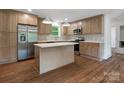 Modern kitchen with stainless steel appliances, an island, and wood cabinets at 4126 Howie Cir, Charlotte, NC 28205