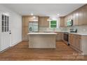 Well-lit kitchen with stainless steel appliances, stylish cabinets, and a spacious island at 4126 Howie Cir, Charlotte, NC 28205