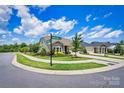 Scenic street view of a well-maintained home on a corner lot, enhanced by lush landscaping and blue skies at 4197 Canopy Creek Dr, Denver, NC 28037