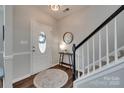 Bright foyer featuring hardwood floors, a staircase with white railings, and a decorative mirror at 424 Castlebury Ct, Clover, SC 29710