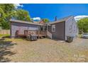 Back of home showing a deck, a brick exterior, and a gravel yard at 432 4Th Street Sw Pl, Hickory, NC 28602