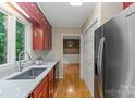 Galley kitchen features stainless steel appliances and lots of light from the window at 460 27Th Avenue Nw Cir, Hickory, NC 28601