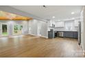 Open-concept living space with hardwood floors, natural light, and modern kitchen featuring stainless steel appliances and stylish cabinetry at 4838 Keats Ave, Charlotte, NC 28212