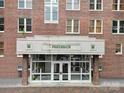 Detailed view of the secure building entrance with brickwork and glass doors at 515 N Church St # 305, Charlotte, NC 28202